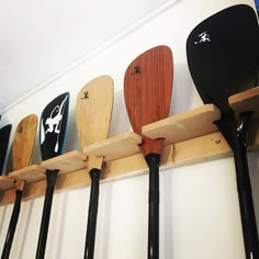 several paddles are hanging on the wall