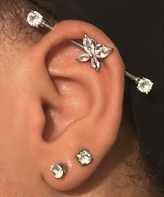 a man with three piercings on his ear and one is wearing an ear cuff