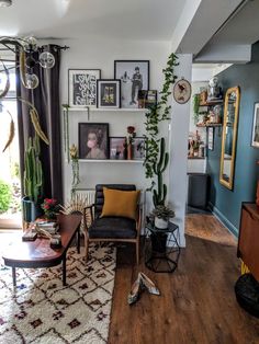 a living room filled with furniture and lots of pictures on the wall next to a window