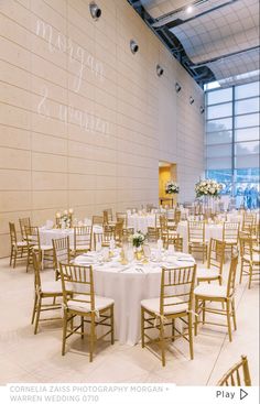 the reception room is set up with white linens and gold chairs