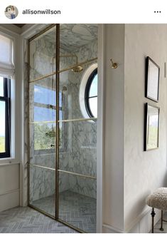 an image of a bathroom setting with marbled walls and flooring in the shower area