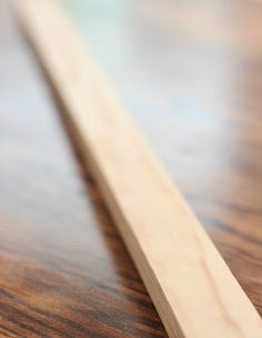 a close up of a piece of wood on a wooden table with blurry background