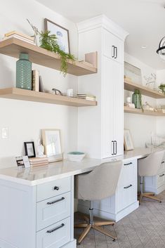 an office with two desks and some shelves