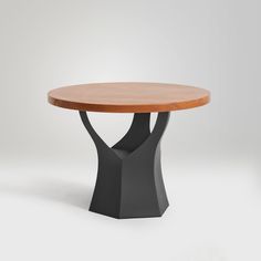 a round wooden table with black legs and a wood top, on a white background