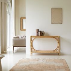 a living room with white walls and beige furniture