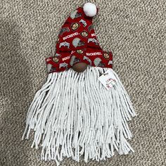 a red and white santa hat on top of a floor