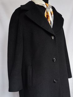 Quality Vintage black wool coat This coat was made in Slovenia. The brand was considered to be of high quality, which is true, the coat is still in wonderful condition. It is made of 70% wool, 15% lambswool, and 15% angora. It is fully lined, and it has raglan sleeves, two front side pockets, and three buttons for buttoning. The great detail is a wide collar, which adds more elegance to this coat. The tag says the size of the coat is 46, but it fits everything between women's size M to XL, depending on how you want to wear it. To be sure, check the exact measurements: Shoulders: 41 cm / 16 in Sleeves (from armpit): 38 cm / 15 in Lenght: 123 cm / 48.5 in All items are measured flat. The colors of the actual items can vary slightly from the colors in the images. The coat has some signs of we Black Single-breasted Pea Coat For Tailoring, Classic Black Wool Coat With Pockets, Classic Black Wool Outerwear, Classic Black Wool Coat With Lapel Collar, Classic Black Wool Coat For Work, Classic Black Pea Coat With Lapel Collar, Black Wool Pea Coat For Office, Classic Black Pea Coat For Cold Weather, Classic Wool Coat With Lapel Collar