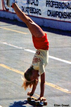 a person doing a handstand on a skateboard