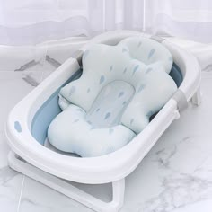 a baby bath tub sitting on top of a white counter