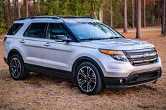 a white ford explorer parked in the woods