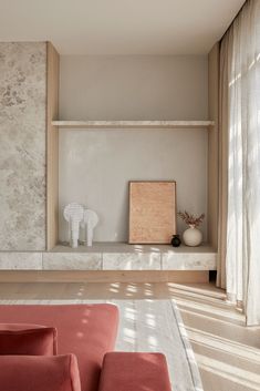 a living room filled with furniture next to a wall mounted book shelf and window sill