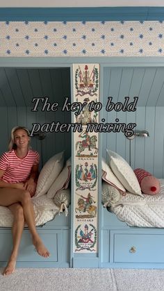 a woman sitting on top of a bunk bed