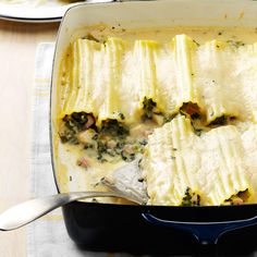 a casserole dish filled with cheese and spinach