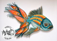 a colorful fish made out of paper on top of a white surface with a black and orange border