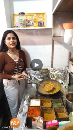 a woman standing in front of a counter filled with food and cooking utensils