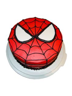 a spiderman cake on a white plate