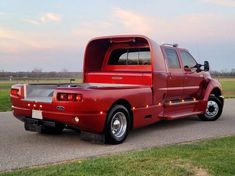 a red truck is parked on the side of the road with its doors open and it's hood up