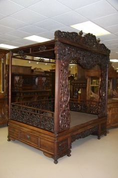 an ornate wooden bed frame in a room