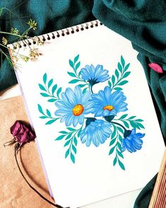 a drawing book with blue flowers on it