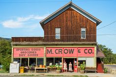 two people standing outside the front of a store