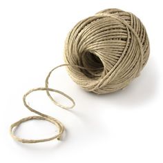 a ball of twine on a white background with a pair of scissors next to it