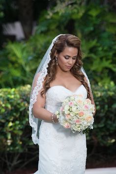 a woman in a wedding dress holding a bouquet