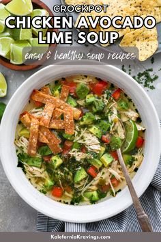 chicken avocado lime soup in a white bowl with tortilla chips on the side