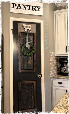 a black door with a wreath on it and the words pantry above it are written in white letters