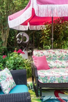 an umbrella and some chairs in a garden