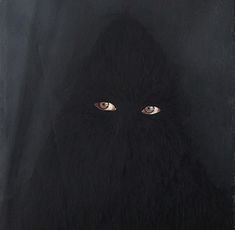 an image of a black face with yellow eyes