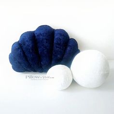 two blue and white balls sitting next to each other on top of a white surface