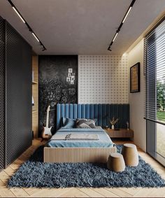 a bedroom with a blue bed in the middle and a chalkboard wall behind it