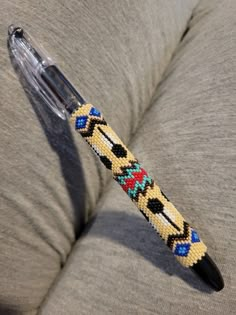 a beaded pen sitting on top of a couch