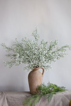 a vase filled with white flowers sitting on top of a table