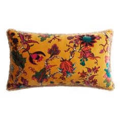 a yellow and red floral pillow on a white background with an embroidered fringe trim around the edge