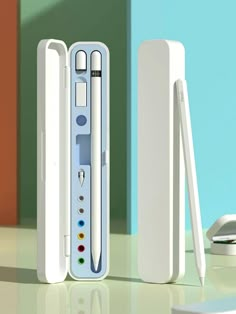 two nintendo wii controllers sitting next to each other on top of a table in front of a blue and green wall