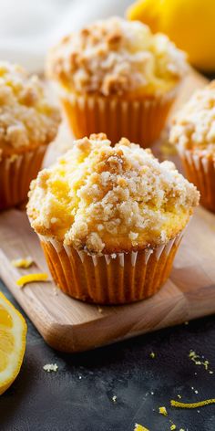 several lemon muffins on a wooden cutting board