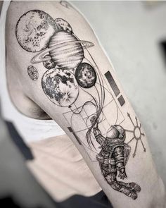 a man with a tattoo on his arm that has an image of the planets in it