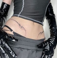 a woman wearing black gloves and tattoos on her stomach