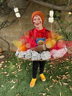 a young boy dressed up as a clown with candy and candies