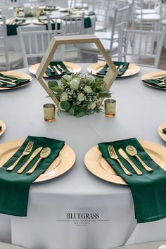 the table is set with gold and green place settings