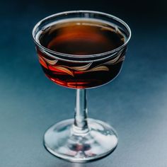 a glass filled with liquid sitting on top of a table