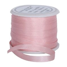 a spool of pink satin ribbon on a white background