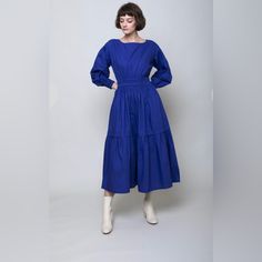 The Estrella Dress Has Smocked Elastic At The Waist And Cuffs To Give This Laid-Back Midi An Easy, Feminine Fit. Cut From Soft Cotton Poplin, The Dress Features A Boat Neckline With Keyhole Closure, Single Tier In Skirt, Dolman Sleeve With Drop Shoulder, Elasticated Smocking At The Waist And Cuffs. Model Is 5'8" And Is Wearing A Size Extra Small. Blue Workwear Dress With Elastic Sleeves, Chic Blue Midi Dress With Smocked Back, Blue Dresses With Gathered Sleeves For Fall, Blue Fall Dresses With Gathered Sleeves, Blue Smocked Midi Dress For Daywear, Blue Knee-length Midi Dress With Smocked Back, Blue Midi Dress With Smocked Bodice, Blue Ruched Midi Smocked Dress, Elegant Blue Midi Smocked Dress