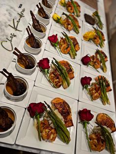 a table topped with white plates filled with food