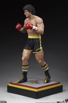 a statue of a man wearing boxing gloves