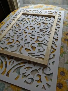 the cut outs are being used to make a decorative wall art piece with wood and paper