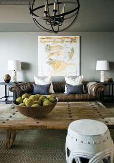 a living room filled with furniture and a bowl of fruit on top of a coffee table