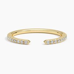 a yellow gold ring with diamonds on it