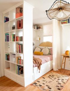 a bed room with a neatly made bed and a book shelf